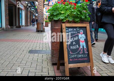 Ashford, Kent, UK. 14th Oct, 2020. Bleak looking high street as more shops have to let and for sale signs on there windows. Be a hero wear a mask sign outside a shop in Park Mall. Photo Credit: Paul Lawrenson-PAL Media/Alamy Live News Stock Photo