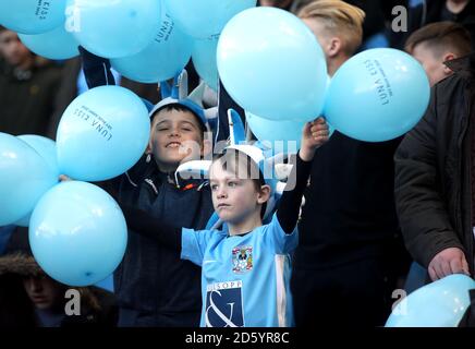 A young Coventry City fan shows his support in the stands Stock Photo