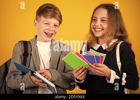 School supplies children need. Happy children hold note books