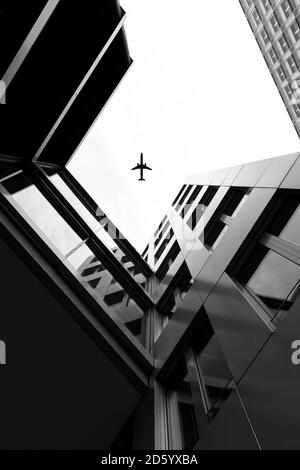 Germany, Duesseldorf, view to plane and facades of high-rise buildings from below Stock Photo