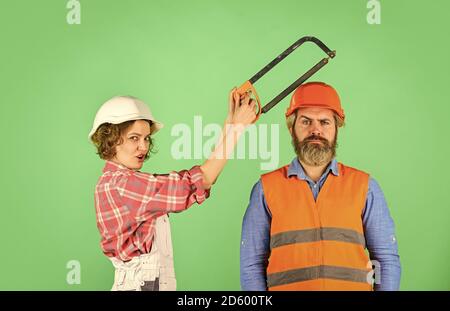 couple is renovating home. couple doing apartment repair together themselves. man and woman wear safety helmet. couple at the construction site. couple making repairs to their home. Home Renovation. Stock Photo