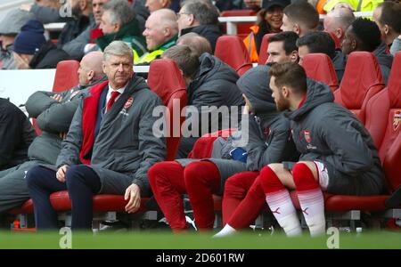 Arsenal manager Arsene Wenger speaks to players on the bench  Stock Photo