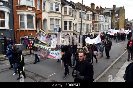 Red, white and black day procession on route to the Valley from Charlton Station Stock Photo