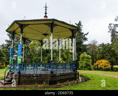 Perthshire, Scotland, United Kingdom, 14th October 2020. UK Weather: Autumn colours. The trees across Perthshire display stunning gold and orange colours on a day that alternated between rain and sunny intervals. Pictured: the Victorian bandstand with 'stay safe' reminders in MacRosty Park or Taylor Park, Crieff Stock Photo