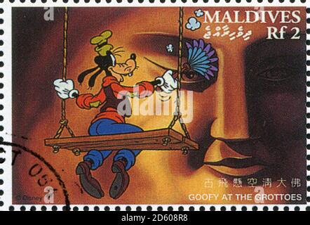 MALDIVE ISLANDS - CIRCA 1996: stamp printed by Maldive Islands, shows Goofy at the grottoes, circa 1996 Stock Photo