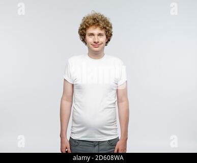 Portrait of smiling blond man wearing white t-shirt Stock Photo