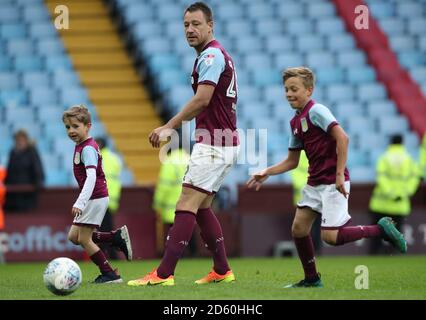 Aston Villa's John Terry (centre) plays a game with his children after the final whistle Stock Photo