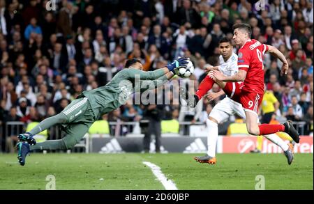 Real Madrid's goalkeeper Keylor Navas (left) saves a shot from Bayern Munich's Robert Lewandowski Stock Photo