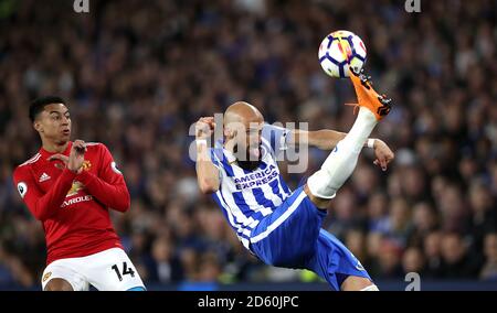 Brighton & Hove Albion's Bruno (centre) clears the ball under pressure from Manchester United's Jesse Lingard (left) Stock Photo
