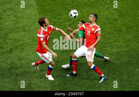 Saudi Arabia's Salem Al-Dawsari (centre) battles for the ball with Russia's Mario Fernandes (left) and Russia's Aleksandr Samedov  Stock Photo