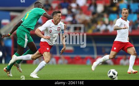 Senegal's Salif Sane (left) fouls Poland's Robert Lewandowski (centre) Stock Photo