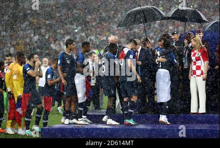 France players receive their winner's medals from FIFA President Gianni Infantino, Russian President Vladimir Putin and French President Emmanuel Macron in the heavy rain after the FIFA World Cup 2018 final at the Luzhniki Stadium in Moscow, 15th July 2018 Stock Photo