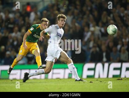 Preston North End's Brandon Barker (left) scores past Leeds United's Patrick Bamford (right)  Stock Photo