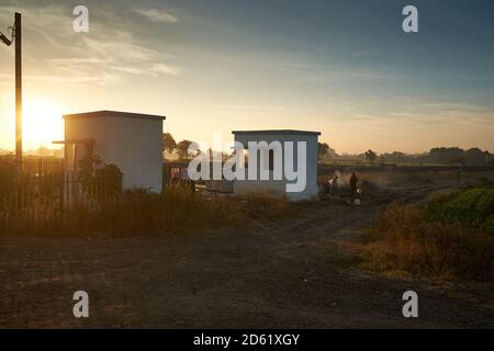 Early morning local village folk out neat a railway crossing somewhere in Ratlam, Madhya Pradesh, India. Stock Photo