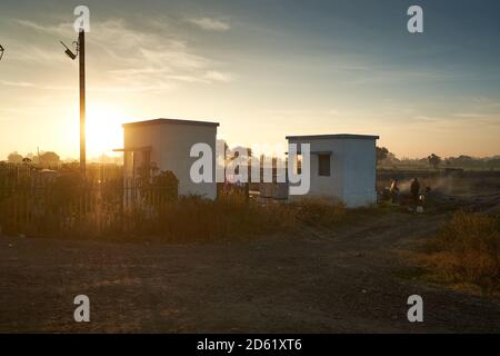 Early morning local village folk out neat a railway crossing somewhere in Ratlam, Madhya Pradesh, India. Stock Photo