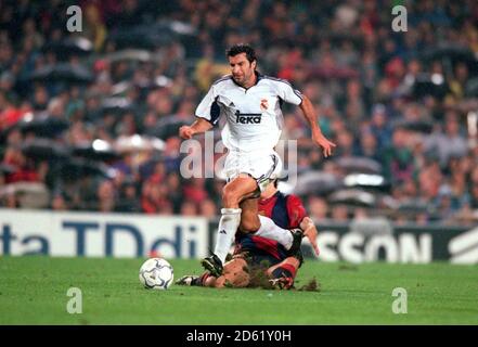 Barcelona's Carles Puyol (r) slides in on Real Madrid's Luis Figo (l) Stock Photo