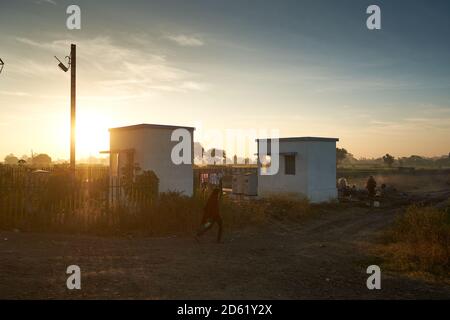 Early morning local village folk out neat a railway crossing somewhere in Ratlam, Madhya Pradesh, India. Stock Photo