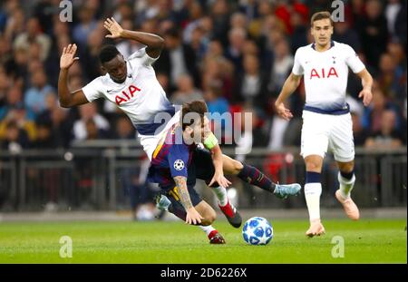 Tottenham Hotspur's Victor Wanyama (left) and Barcelona's Lionel Messi battle for the ball Stock Photo