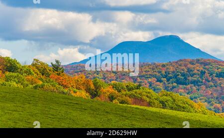 view of Camels Hump Mountain in fall foliage season, in Vermont