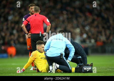 Manchester City goalkeeper Ederson receives medical treatment after a tackle with Tottenham Hotspur's Harry Kane (not pictured) Stock Photo