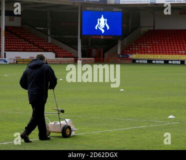 Ground staff prepare the pitch before the match Stock Photo