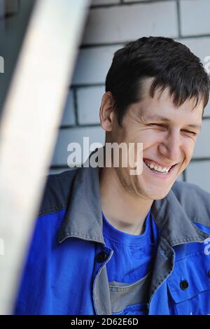 A cheerful and happy employee smiles at the workplace Stock Photo