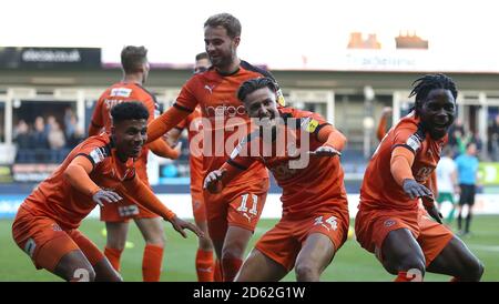 Luton Town's James Justin (left) celebrates scoring his side's third goal of the game with Harry Cornick (centre) and Pelly-Ruddock Mpanza (right)  Stock Photo