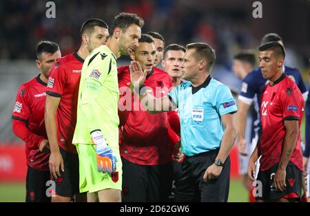 Referee Vladislav Bezborodov (right) speaks with Albania goalkeeper Etrit Berisha Stock Photo