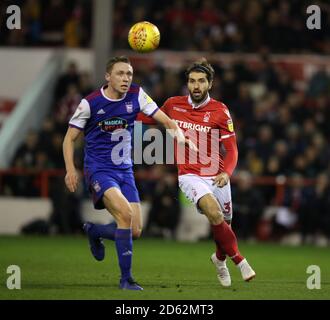 Nottingham Forest's Karim Ansarifard (right) and Ipswich Town's Mathew Pennington during the Sky Bet Championship match at the City Ground Nottingham  Stock Photo