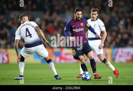 Tottenham Hotspur's Toby Alderweireld (left) and Barcelona's Lionel Messi (centre) battle for the ball Stock Photo