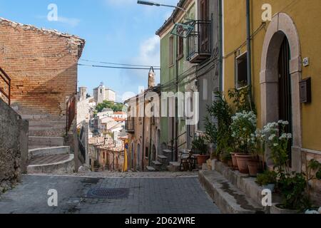 A typical street of the Italian village Torrella del Sannio in Molise, with some white flowers pots on the sidewalk Stock Photo