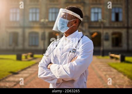Thoughtful male physician looking in the distance Stock Photo