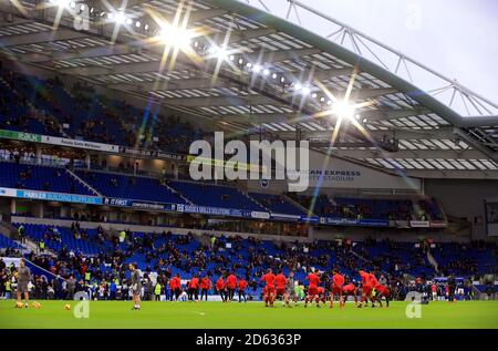 Liverpool's players warm up before the match at the AMEX Stadium Stock Photo