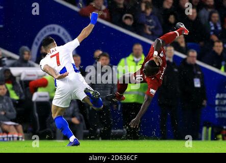 Liverpool's Sadio Mane goes down after the tackle by Brighton & Hove Albion's Beram Kayal Stock Photo