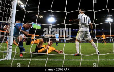 Manchester City's Gabriel Jesus (left) glides into the goal post Stock Photo