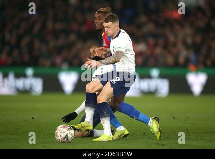 Crystal Palace's Wilfried Zaha (centre) is tackled by Tottenham Hotspur's Kieran Trippier (right) and Rodrigues Lucas Moura Stock Photo