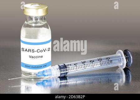 Vaccination against the new Corona Virus SARS-CoV-2: A syringe and a SARS-CoV-2 vaccine Stock Photo