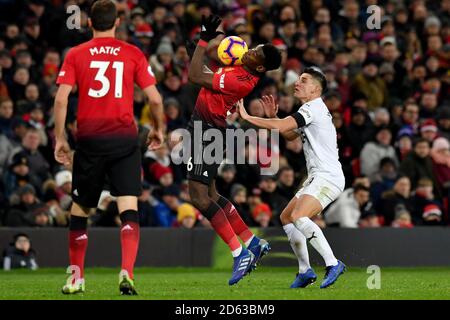 Burnley's Ashley Westwood (right) and Manchester United's Paul Pogba (centre) battle for the ball  Stock Photo