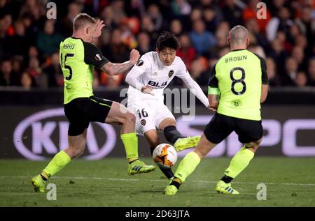 Valencia's Kang-In Lee shoots under pressure from Celtic's Jonny Hayes and Scott Brown Stock Photo