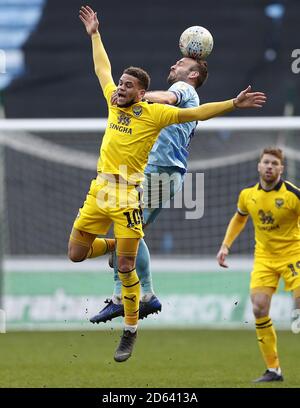 Oxford United's Marcus Browne (left) battles for a header with Coventry City's Liam Kelly Stock Photo