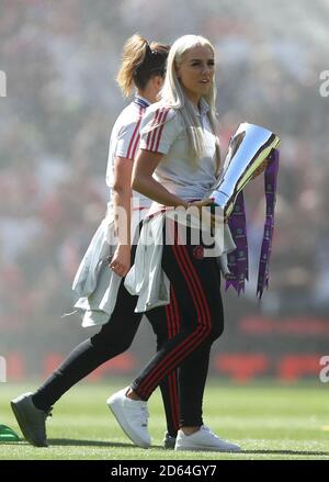 Manchester United's Alex Greenwood with the FA Womens Super League 2 Trophy on the pitch before kick-off
