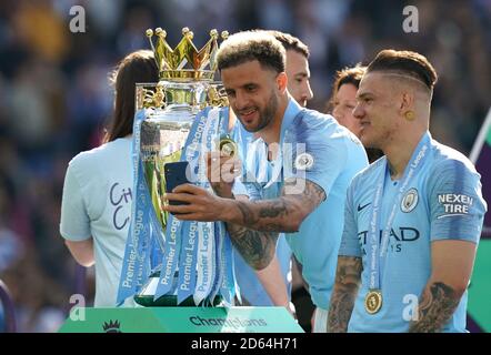 Manchester City's Kyle Walker takes a selfie with the trophy after the match Stock Photo