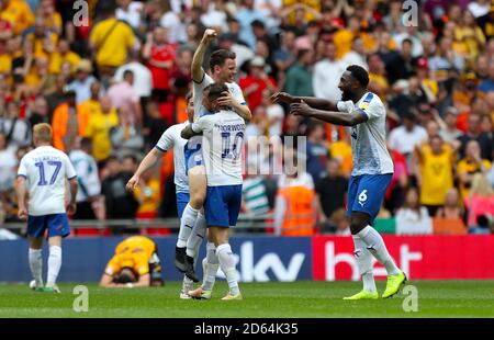 (left to right) Tranmere Rovers' Connor Jennings, James Norwood and Emmanuel Monthe celebrate promotion to league one after the final whistle Stock Photo