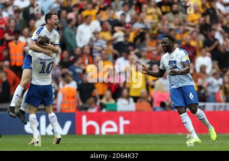 (left to right) Tranmere Rovers' Connor Jennings, James Norwood and Emmanuel Monthe celebrate promotion to league one after the final whistle Stock Photo