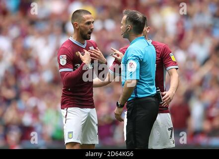 Aston Villa's Conor Hourihane (left) speaks to referee Paul Tierney during the game Stock Photo