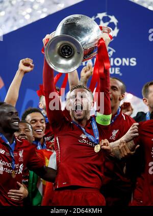 Liverpool's Jordan Henderson celebrates with the trophy during the UEFA Champions League Final at the Wanda Metropolitano, Madrid. Stock Photo