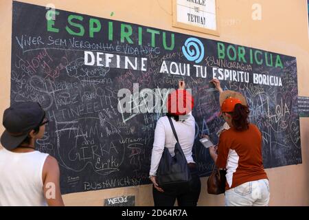 Espiritu Boricua Define Aqui Tu Espiritu Boricua chalk art wall on Calle Tetuan in Old San Juan Puerto Rico.Many small brands is a “Collective Spirit” Stock Photo