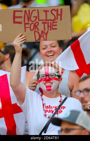An england fan holds a banner in the stands Stock Photo