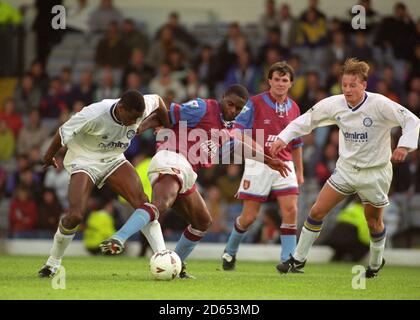 Chris Fairclough (l), Leeds United, is tackled by Dalian Atkinson, Aston Villa, with David Batty (r), Leeds United, following the action. Stock Photo