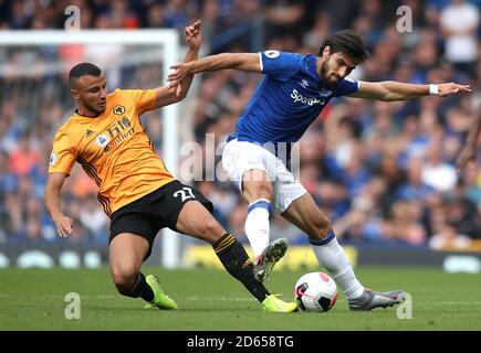 Wolverhampton Wanderers' Romain Saiss (left) and Everton's Andre Gomes battle for the ball Stock Photo